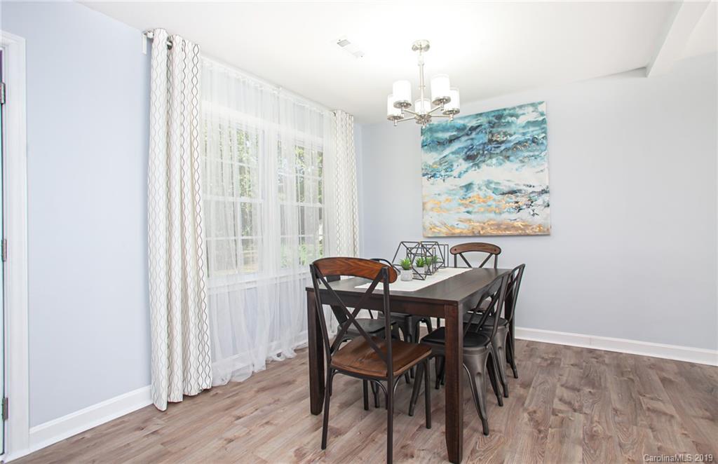 3607 Round Oak Road Charlotte, NC 28210 - Photo 22 of 36 a view of a dining room with furniture large window and wooden floor