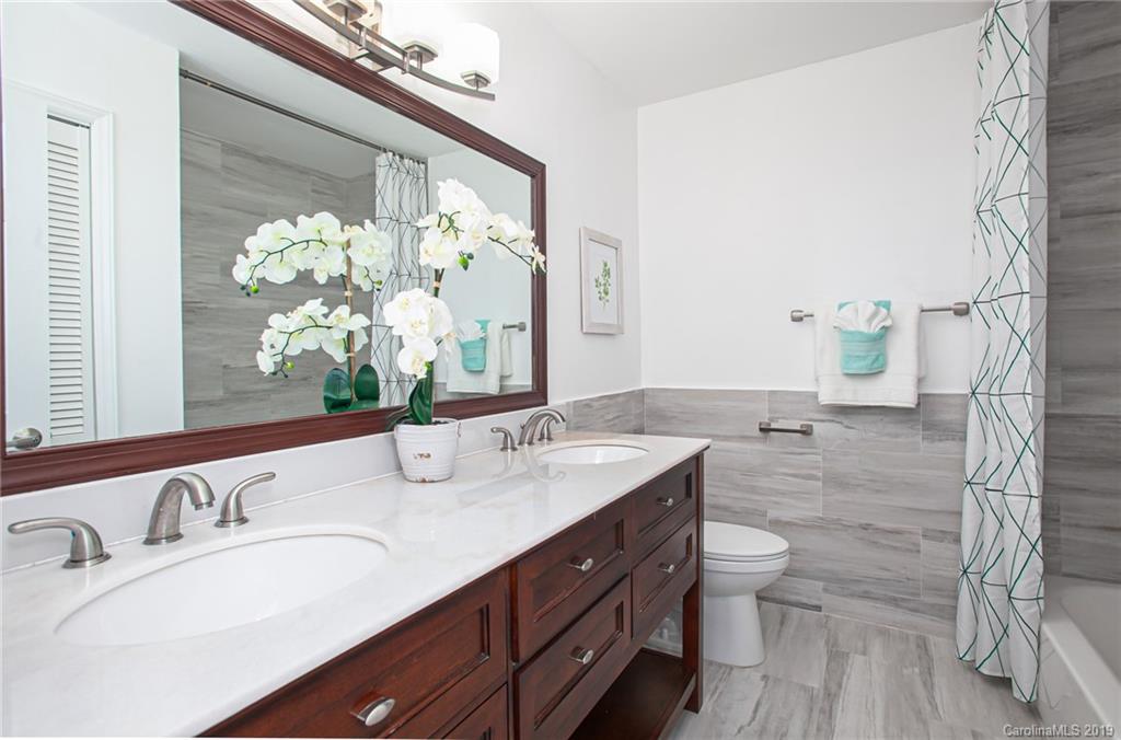 3607 Round Oak Road Charlotte, NC 28210 - Photo 26 of 36 a bathroom with a double vanity sink and a mirror