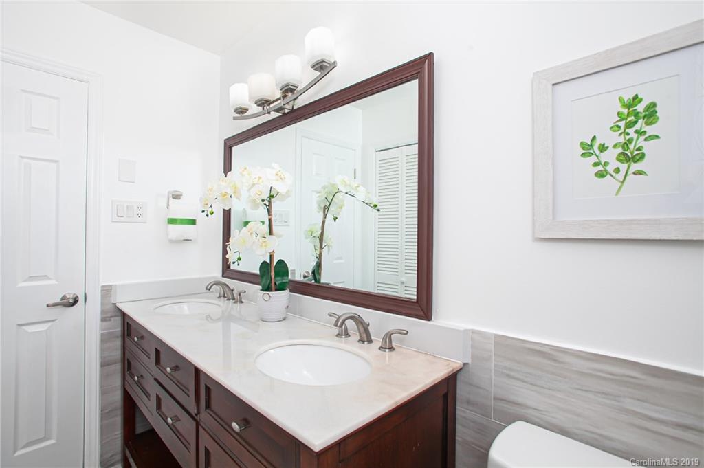 3607 Round Oak Road Charlotte, NC 28210 - Photo 27 of 36 a bathroom with a double vanity sink and a mirror