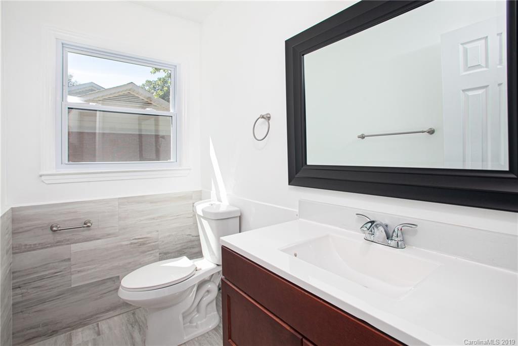 3607 Round Oak Road Charlotte, NC 28210 - Photo 29 of 36 a bathroom with a sink a toilet and a mirror