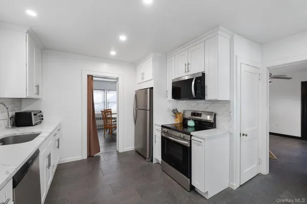 a kitchen with stainless steel appliances a stove microwave and refrigerator