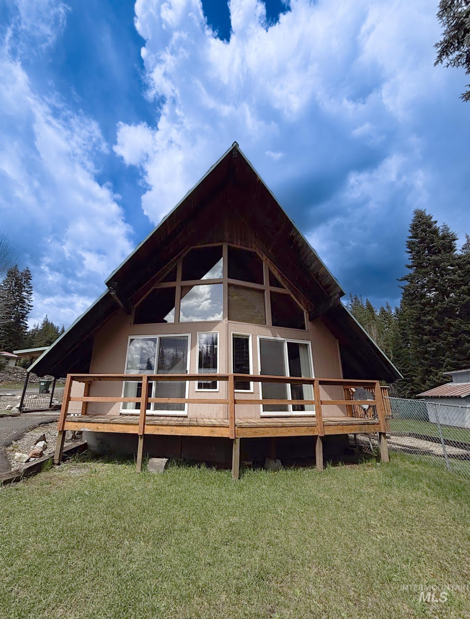 302 Rossiter Court Pierce, ID 83546 - Photo 2 of 30 A-frame residence featuring a prominent pitched roof and a facade with expansive window arrangements