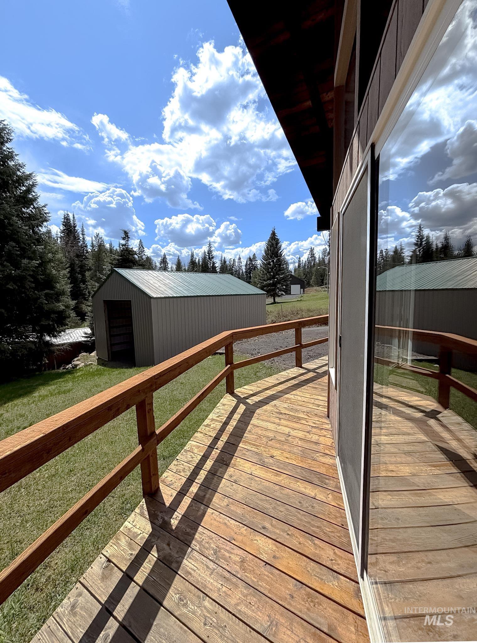302 Rossiter Court Pierce, ID 83546 - Photo 24 of 30 Expansive wood deck with a stained wood railing