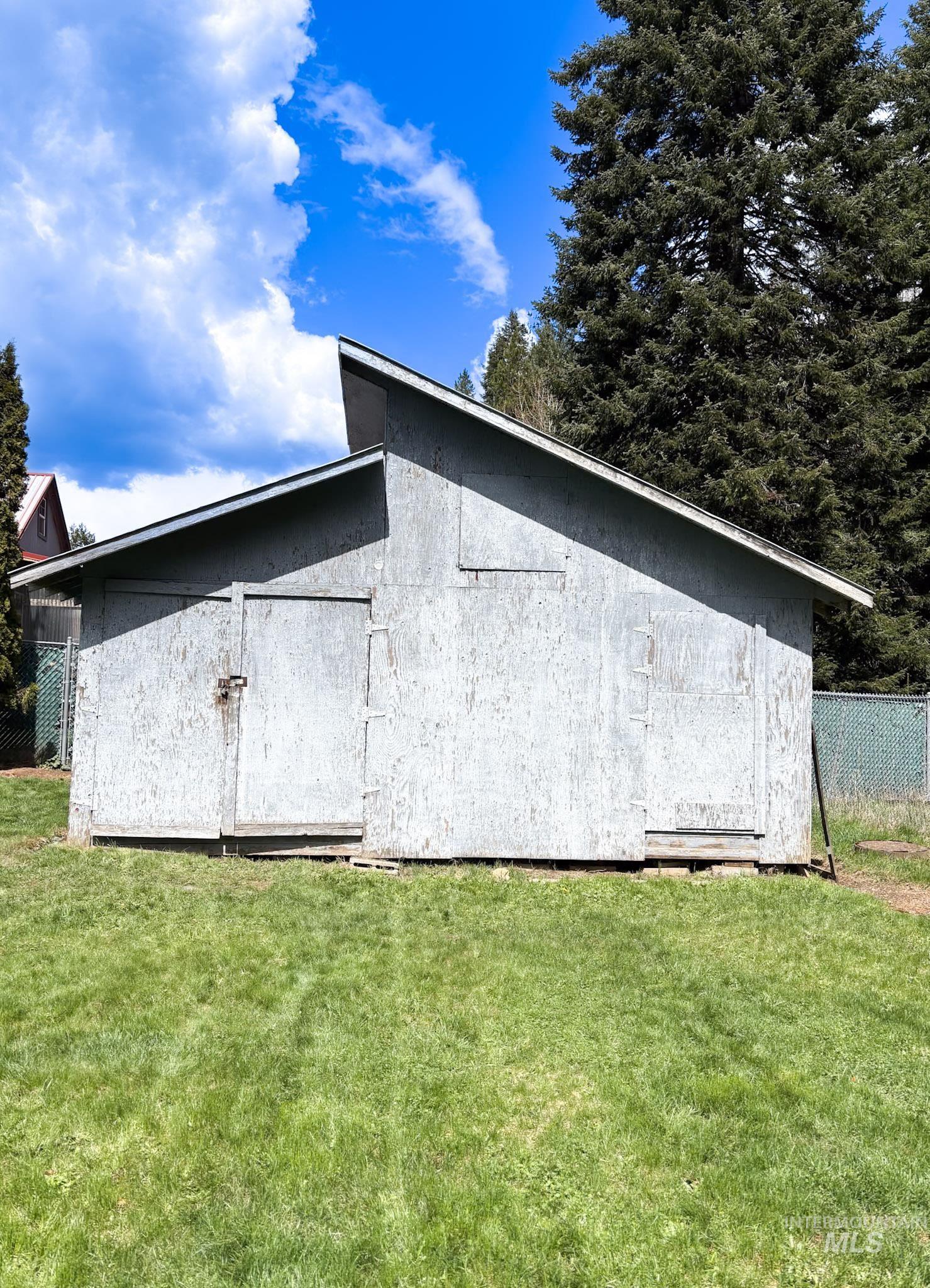 302 Rossiter Court Pierce, ID 83546 - Photo 29 of 30 Detached shed with a single-pitch roofline, dual sliding doors, and a natural grass surround