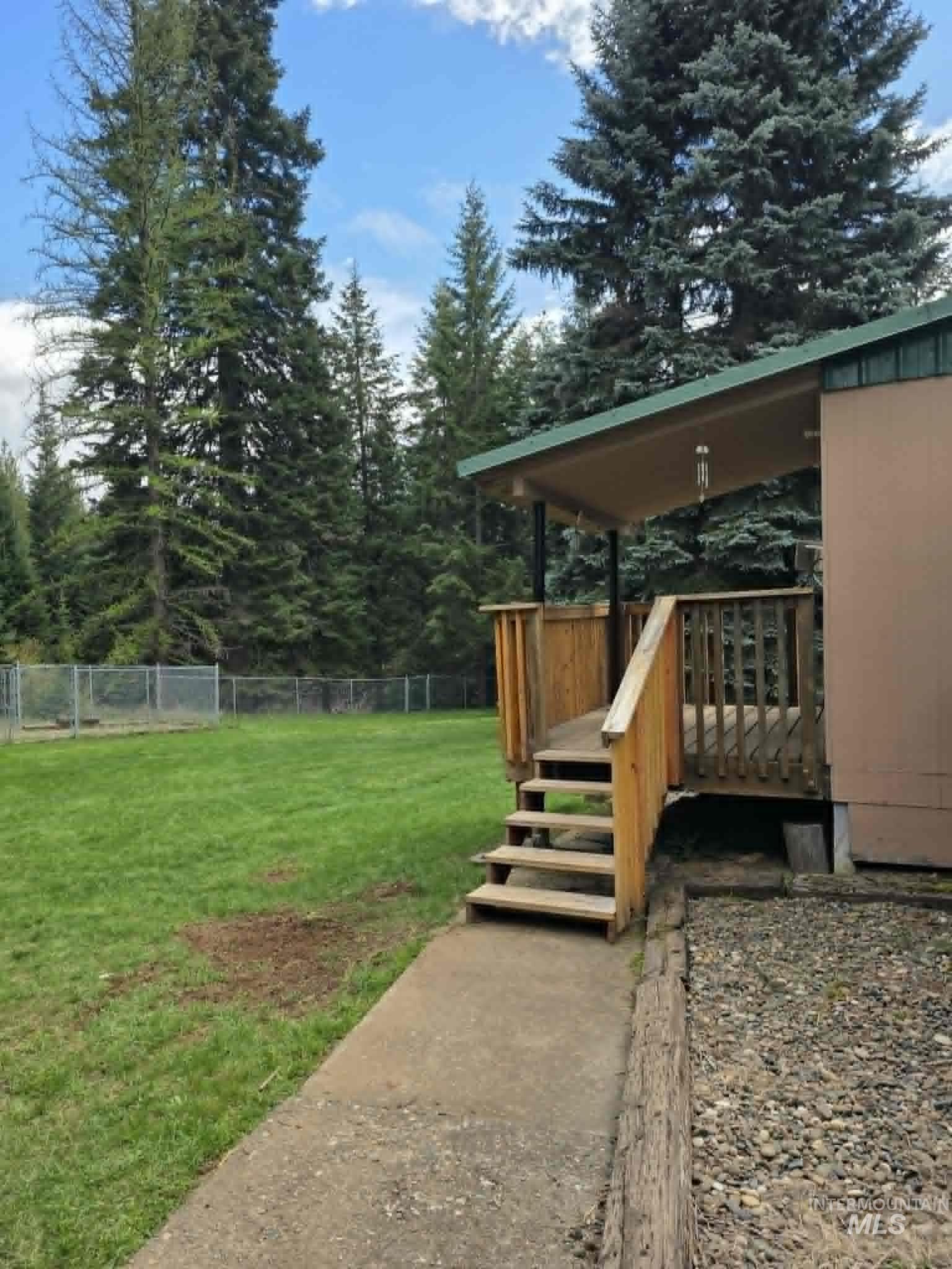 302 Rossiter Court Pierce, ID 83546 - Photo 30 of 30 Covered wood deck entrance with wood stairs and railing