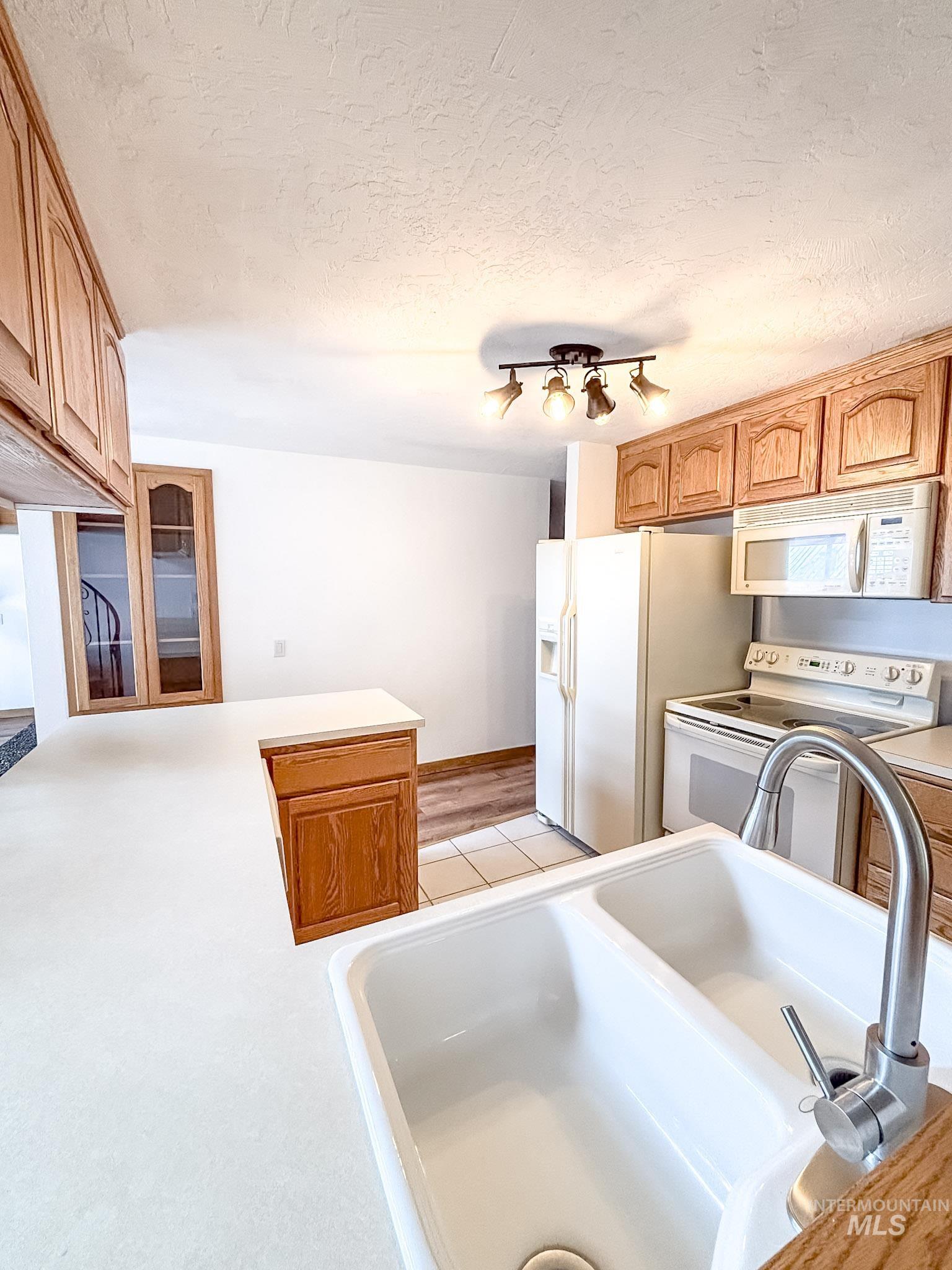 302 Rossiter Court Pierce, ID 83546 - Photo 8 of 30 Kitchen featuring light wood cabinetry and white countertops