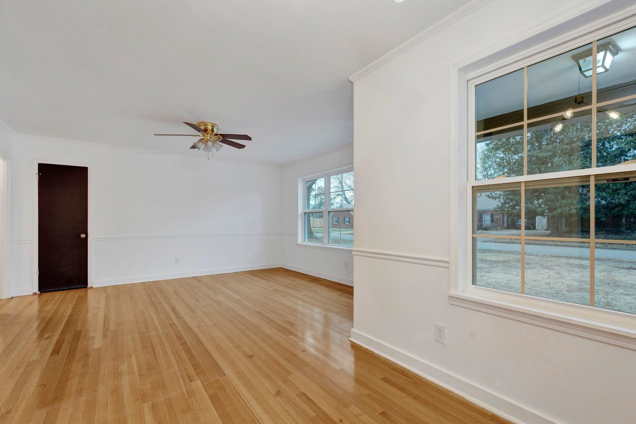 Unfurnished room with crown molding, light hardwood / wood-style flooring, and ceiling fan