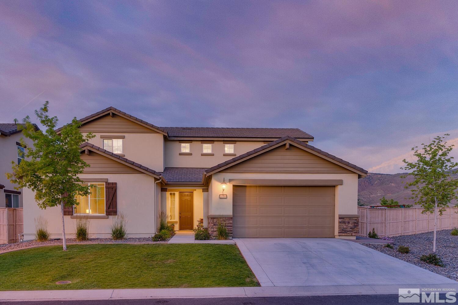 a front view of a house with a yard and garage