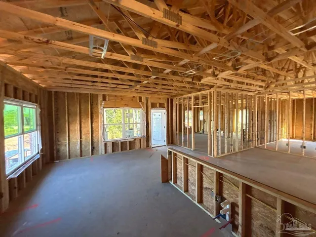 a view of a hall with wooden floor and windows