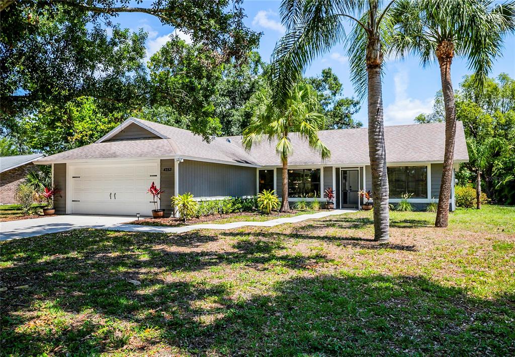 4253 Prairie View Drive South Sarasota, FL 34232 - Photo 1 of 1 a front view of a house with a yard and garage