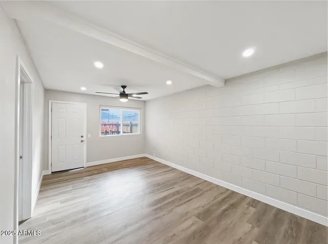 wooden floor in an empty room with a window