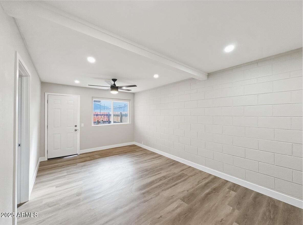 513 East Hatcher Road, Unit 6 Phoenix, AZ 85020 - Photo 2 of 8 wooden floor in an empty room with a window