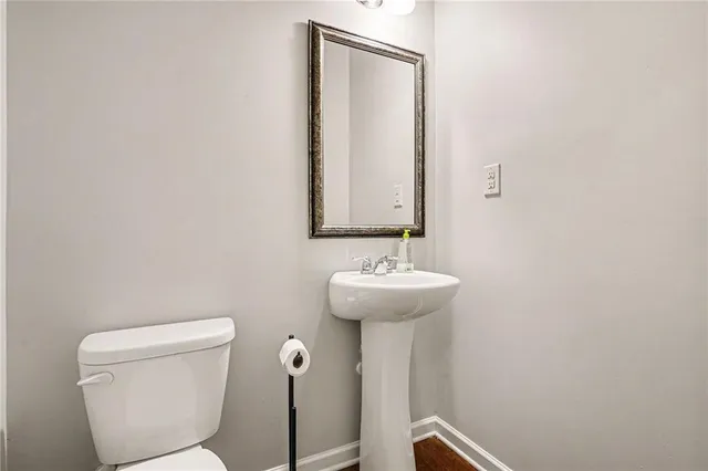 a bathroom with a sink a toilet and mirror