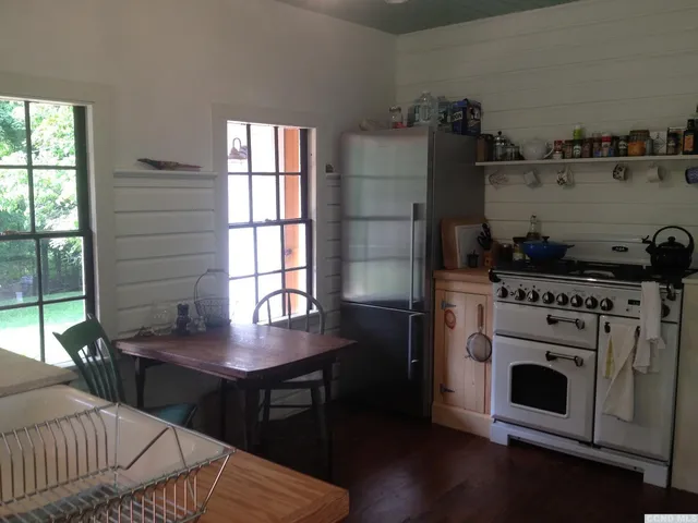 a kitchen with stainless steel appliances granite countertop a stove a refrigerator and a microwave