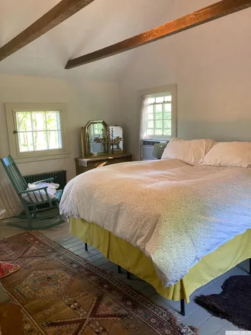 a bedroom with a bed and window