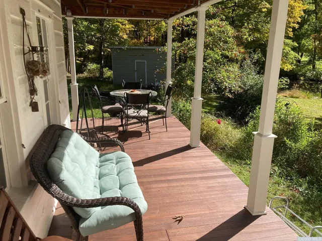 a view of a house with backyard and porch