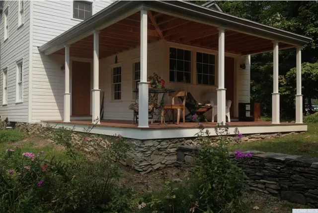 a backyard of a house with a yard and outdoor seating