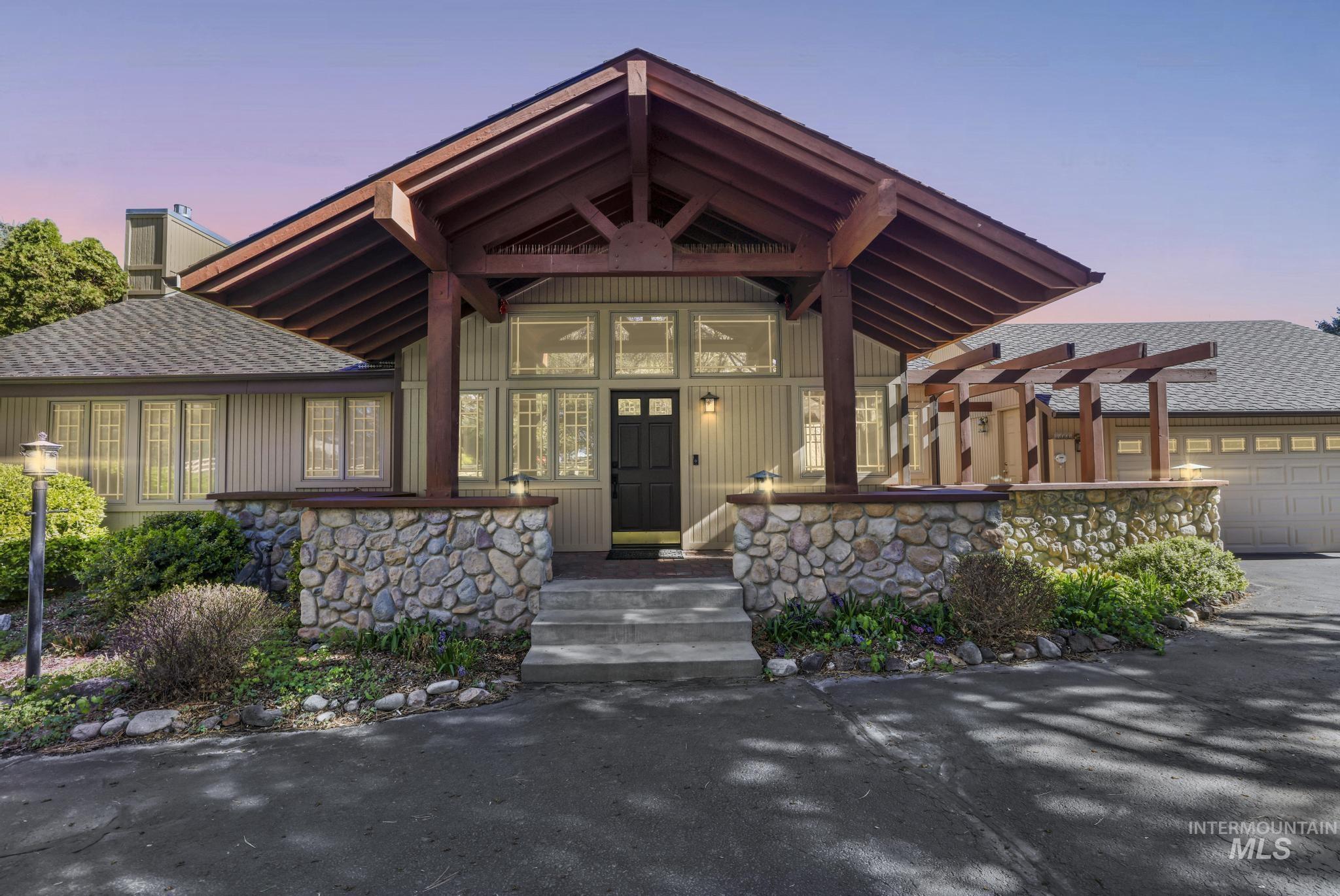 1172 Hankins Road North Twin Falls, ID 83301 - Photo 1 of 49 View of front of property with a garage, roof with shingles, driveway, and stone siding