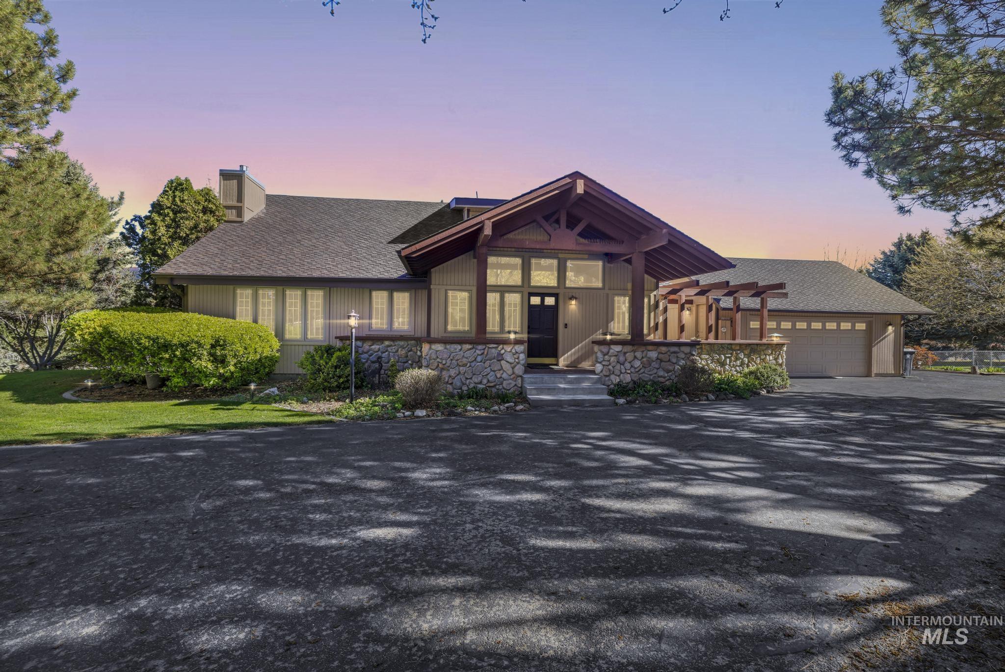 1172 Hankins Road North Twin Falls, ID 83301 - Photo 2 of 49 View of front facade featuring driveway, a chimney, a shingled roof, and an attached garage