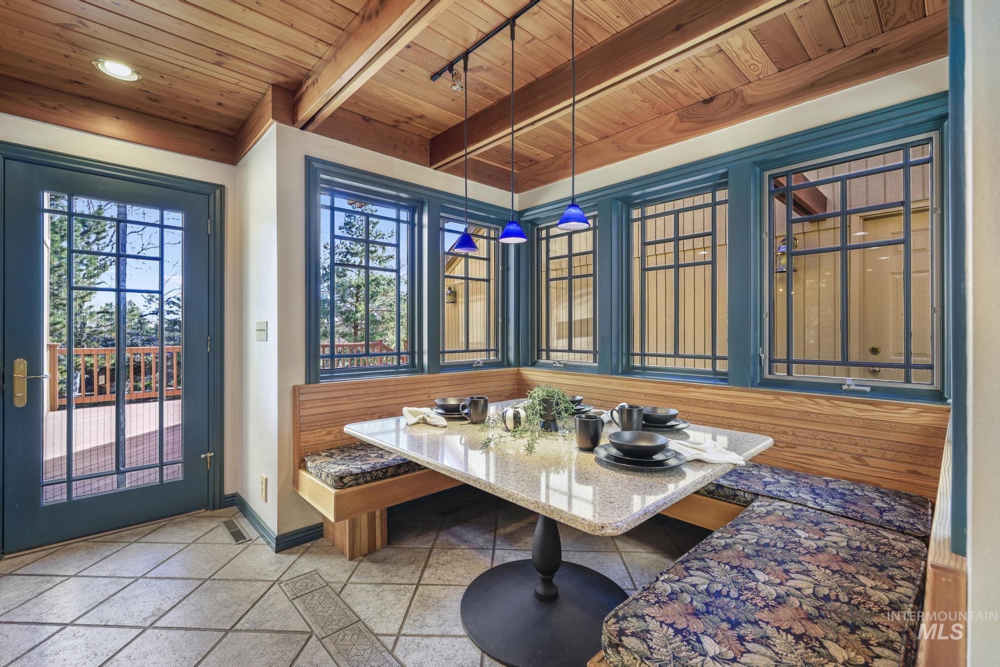 1172 Hankins Road North Twin Falls, ID 83301 - Photo 21 of 49 Dining space featuring baseboards and a wooden ceiling with exposed beams