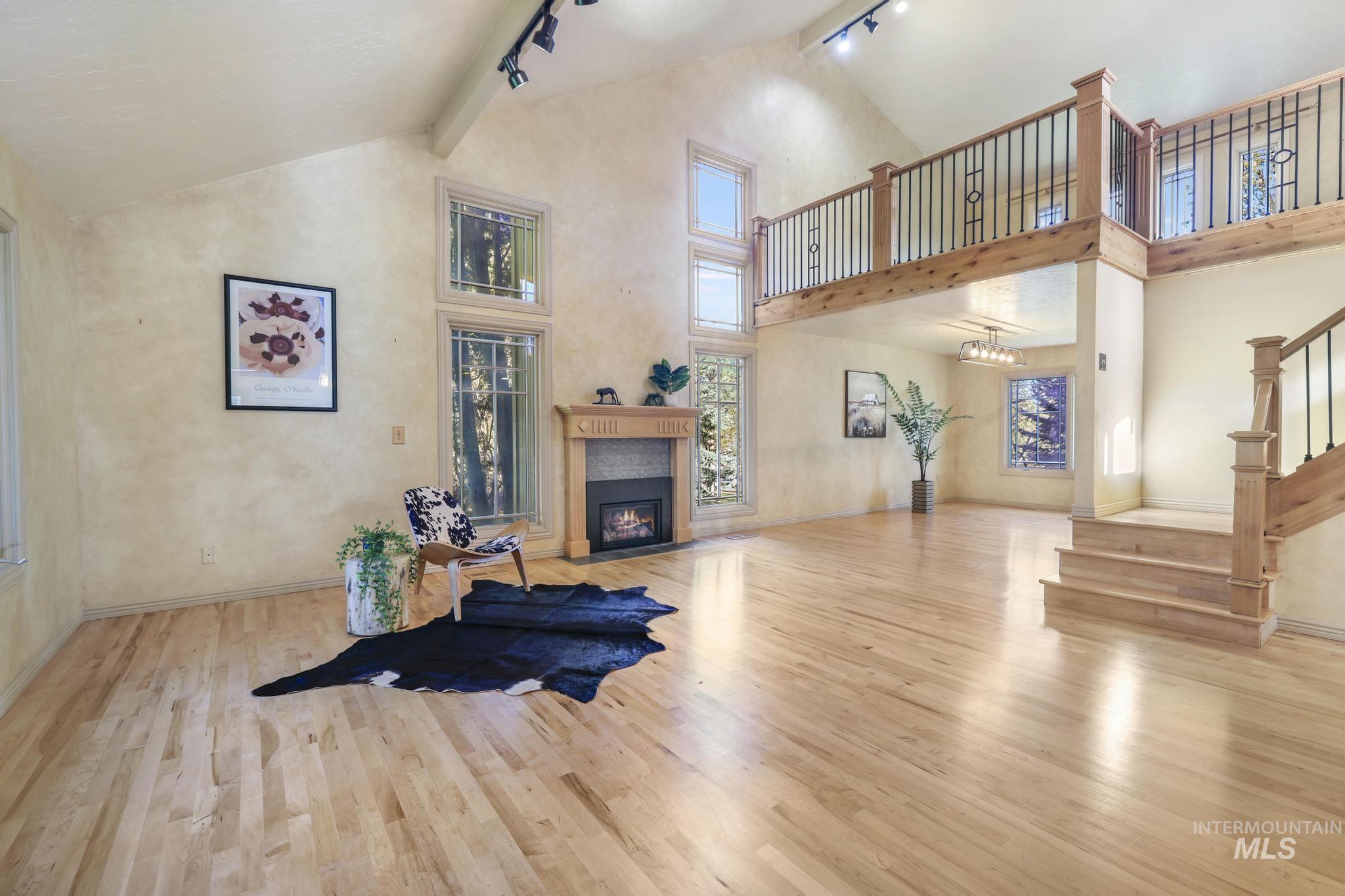 1172 Hankins Road North Twin Falls, ID 83301 - Photo 25 of 49 Living area with track lighting, light wood-style floors, and a fireplace with flush hearth