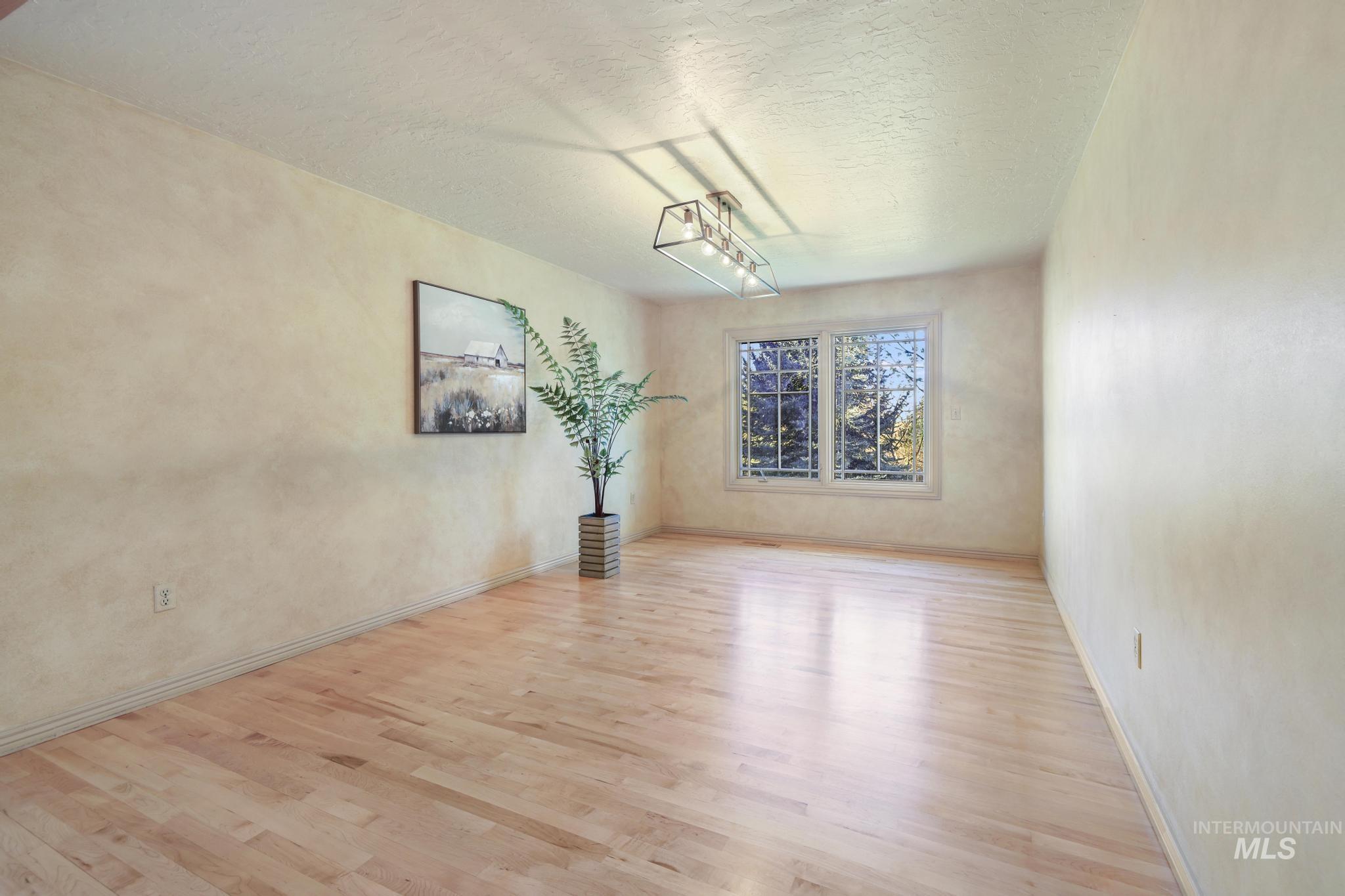 1172 Hankins Road North Twin Falls, ID 83301 - Photo 28 of 49 Unfurnished dining area with light wood-style floors and a textured ceiling