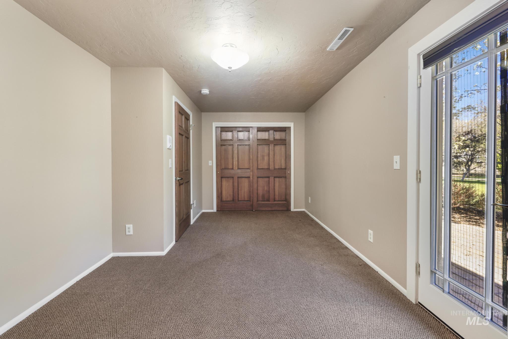 1172 Hankins Road North Twin Falls, ID 83301 - Photo 43 of 49 Spare room featuring carpet flooring and a textured ceiling