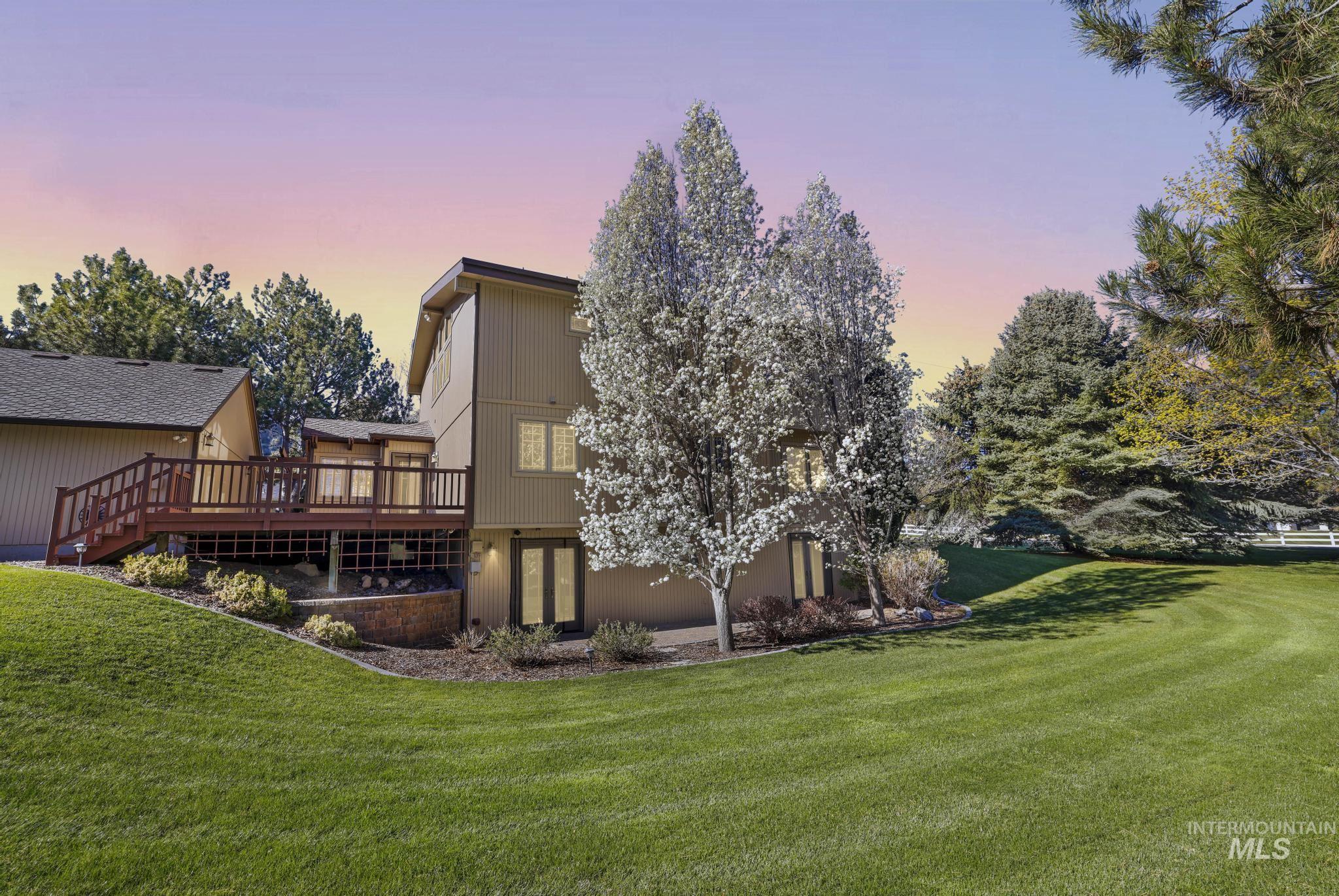 1172 Hankins Road North Twin Falls, ID 83301 - Photo 5 of 49 Rear view of house featuring a yard and a wooden deck