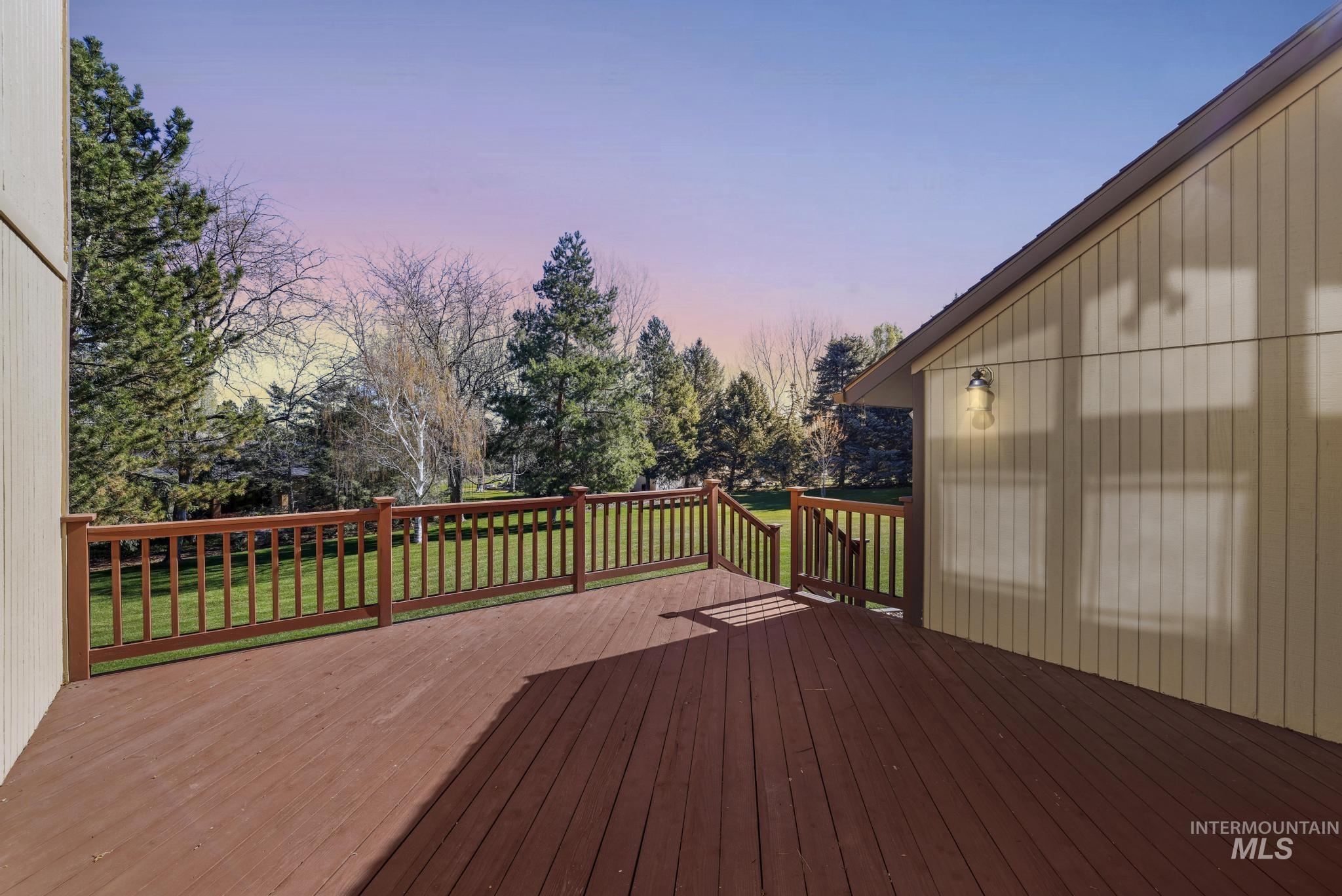 1172 Hankins Road North Twin Falls, ID 83301 - Photo 9 of 49 Deck at dusk featuring a lawn