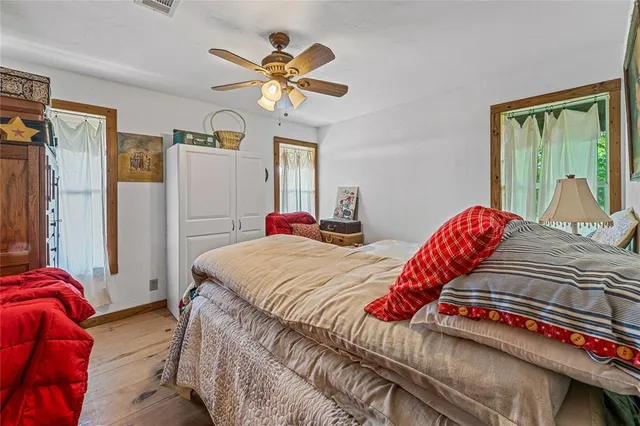 a bedroom with a bed and a large window
