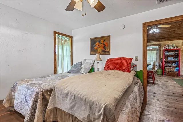 a bedroom with a bed and a chandelier