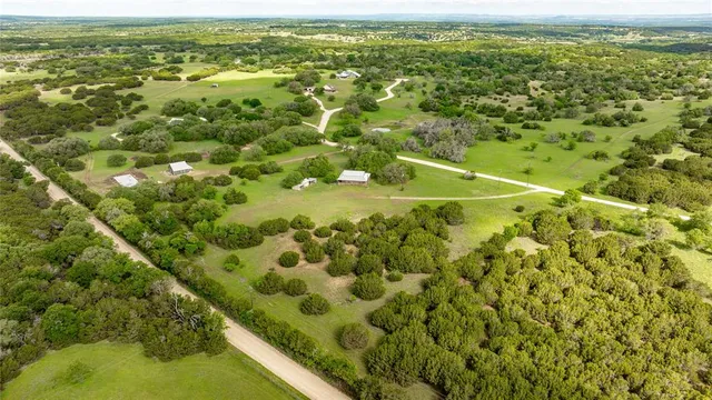 an aerial view of a residential houses with outdoor space and street view