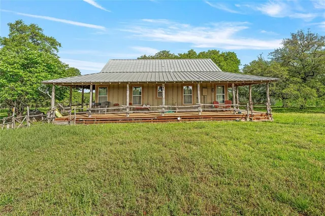 a front view of a house with a yard table and chairs