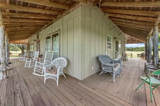 a patio with wooden cabinets and outdoor seating