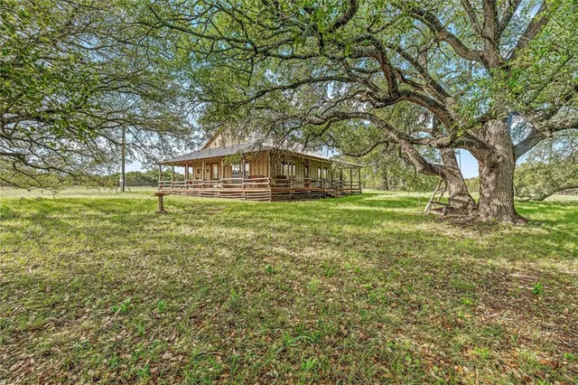 a front view of a house with a yard table and chairs