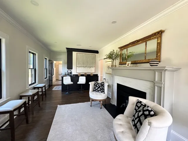 a living room with furniture fireplace and window