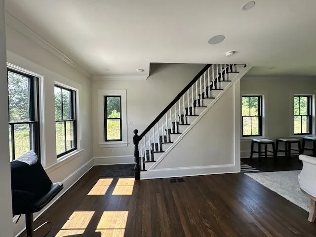 a view of an entryway with wooden floor and door