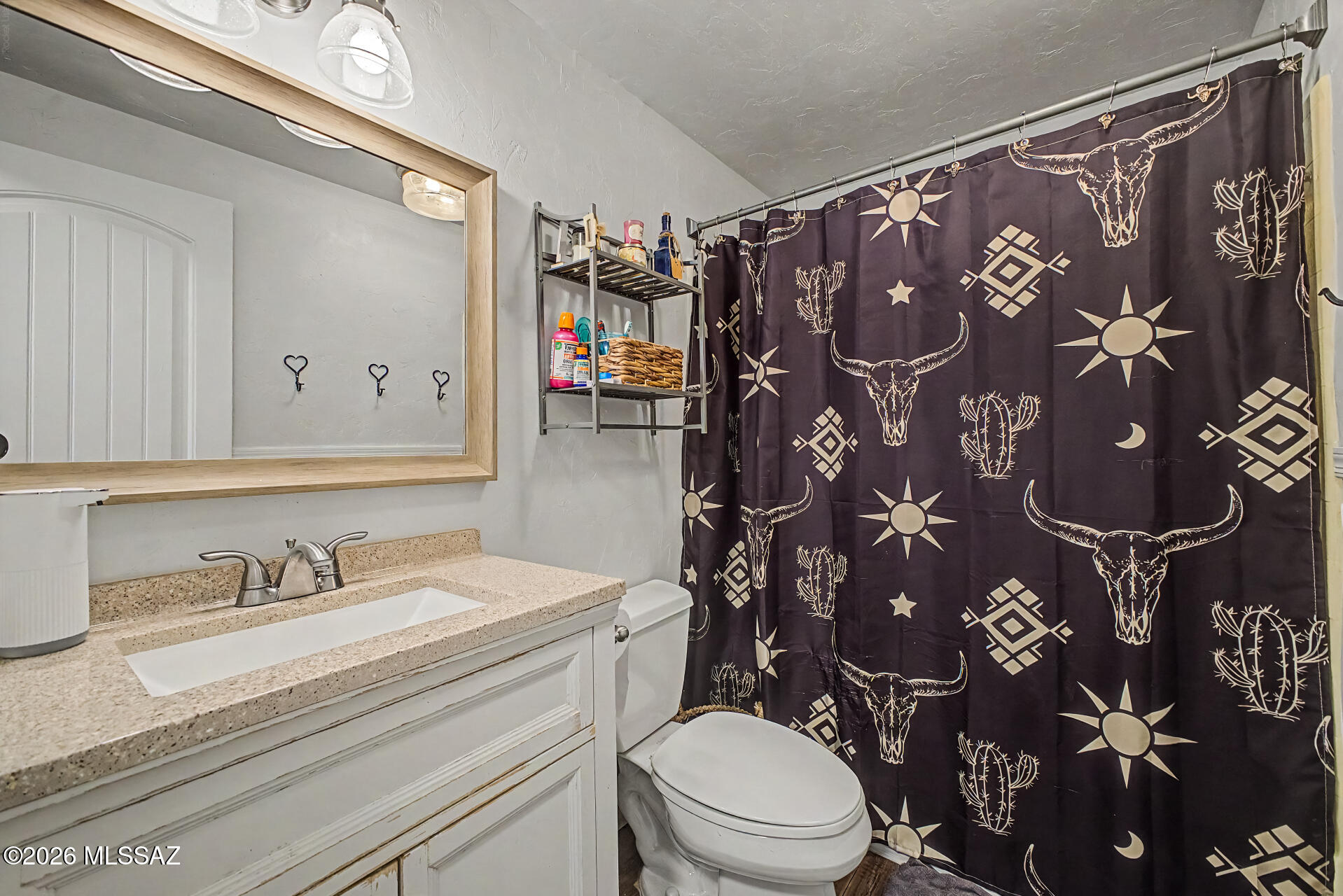 4231 East Pinal Street Tucson, AZ 85739 - Photo 19 of 36 a bathroom with a sink toilet and shower