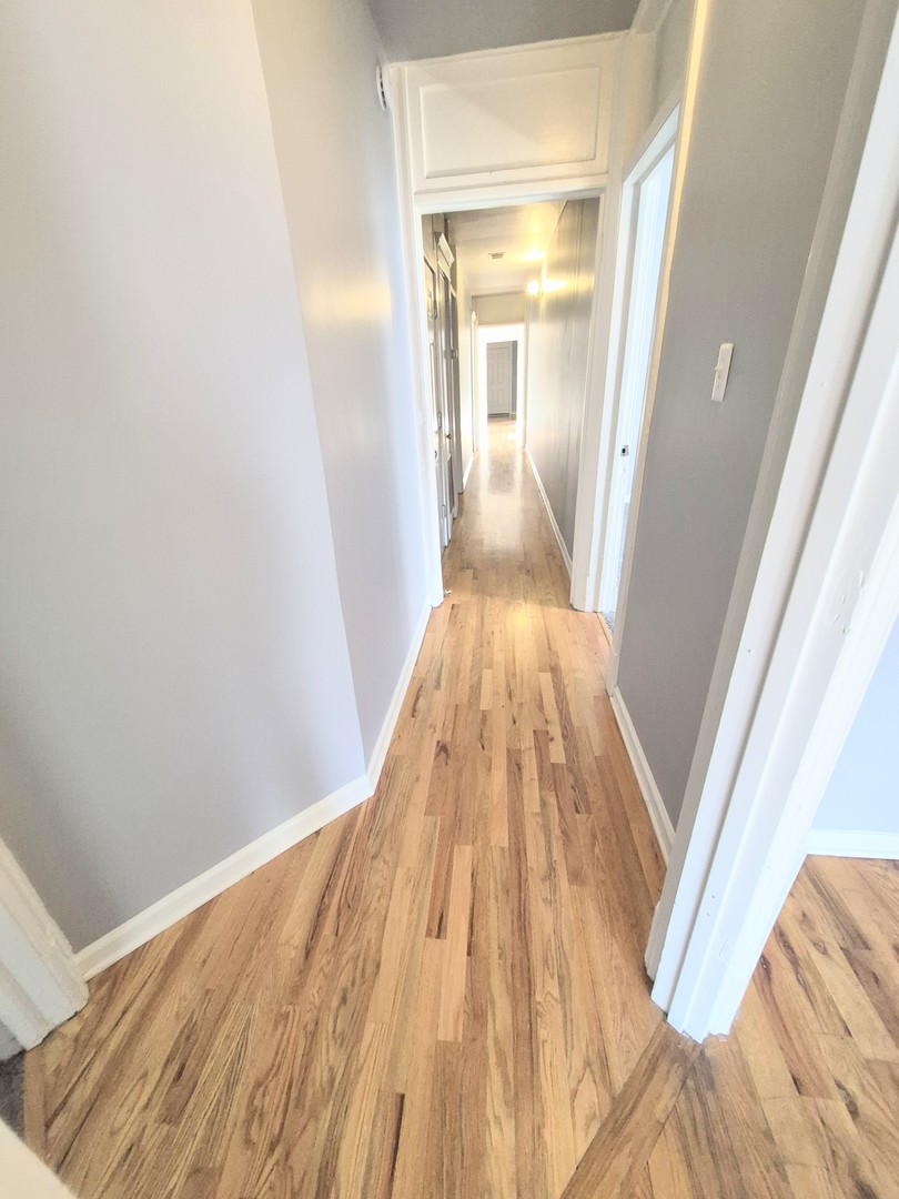 4243 South Calumet Avenue, Unit 2 Chicago, IL 60653 - Photo 4 of 8 a view of a hallway with wooden floor