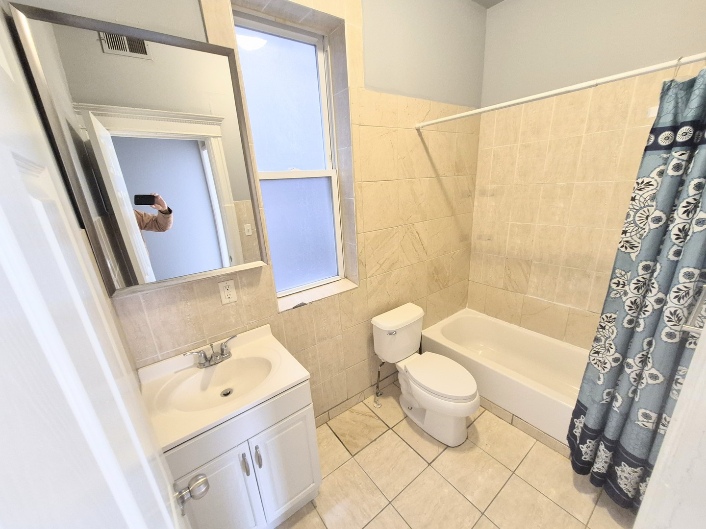 4243 South Calumet Avenue, Unit 2 Chicago, IL 60653 - Photo 6 of 8 a bathroom with a sink a toilet and shower