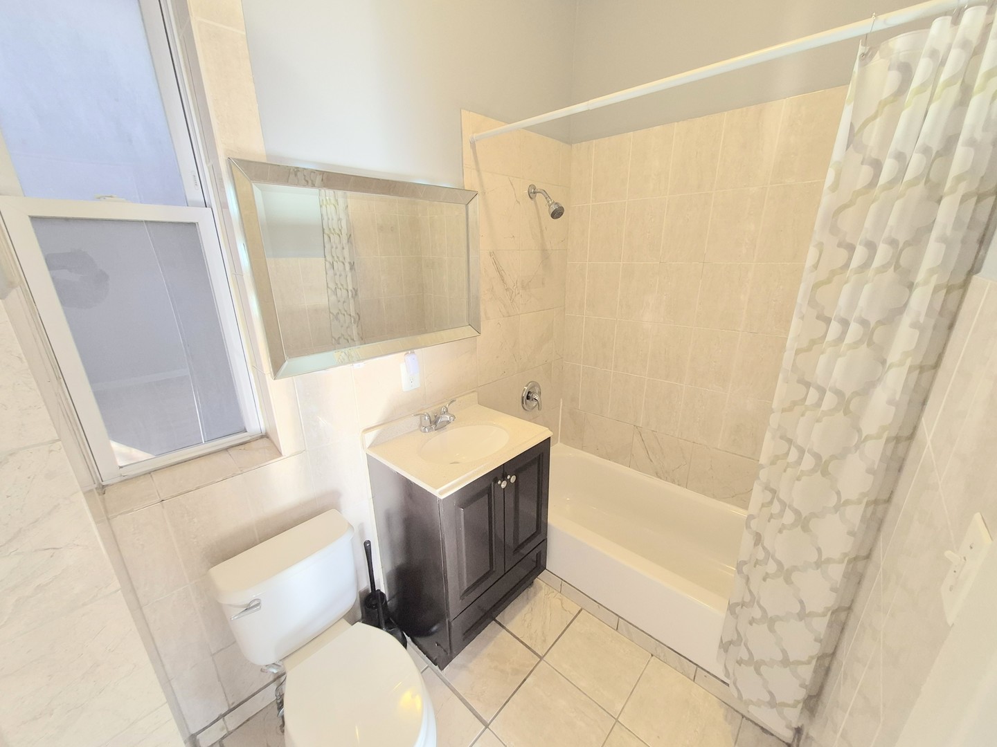 4243 South Calumet Avenue, Unit 2 Chicago, IL 60653 - Photo 7 of 8 a bathroom with a sink a toilet and shower