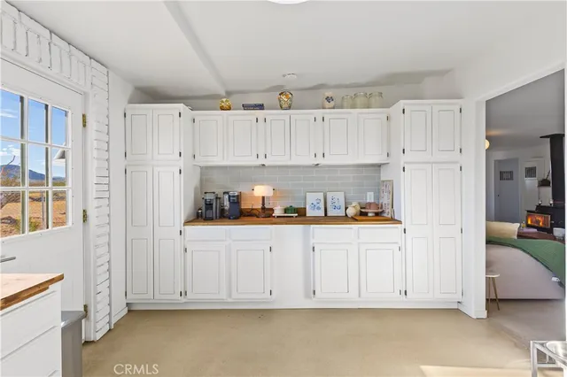 a view of kitchen with white cabinets