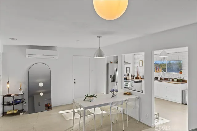 a living room with furniture a table and kitchen chandelier