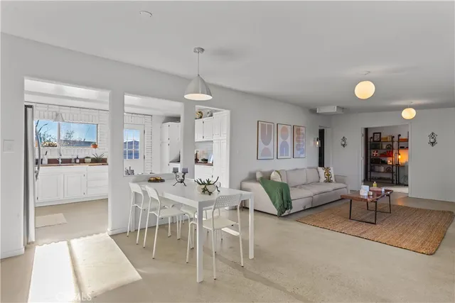 a living room with furniture and view of kitchen