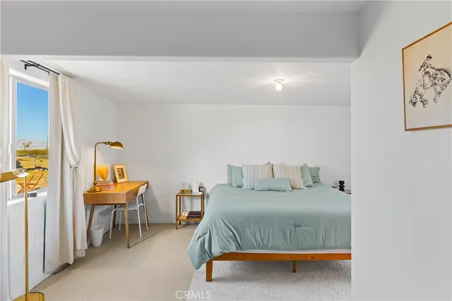 a bedroom with a bed and window