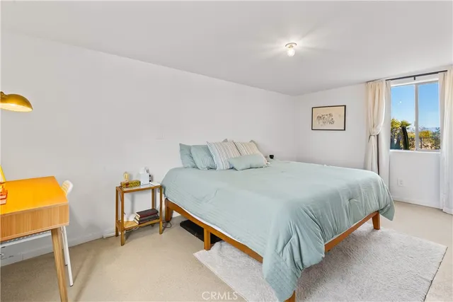 a bedroom with a bed and table