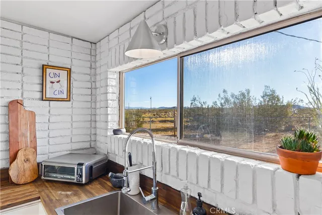 a view of a chairs and table in a balcony