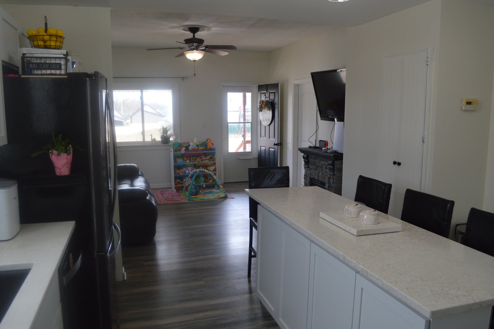 108 North Milwaukee Street Mark, IL 61340 - Photo 13 of 29 a living room with furniture a fireplace and a flat screen tv