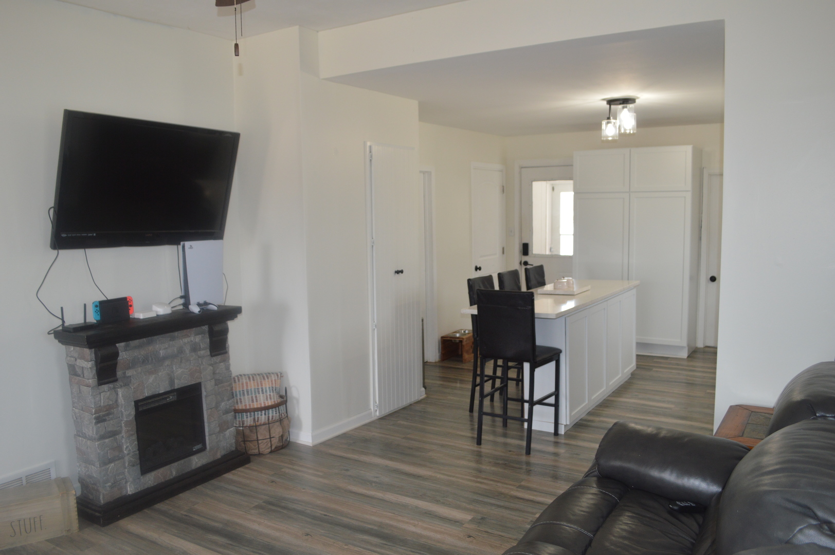 108 North Milwaukee Street Mark, IL 61340 - Photo 7 of 29 a living room with furniture a fireplace and a flat screen tv