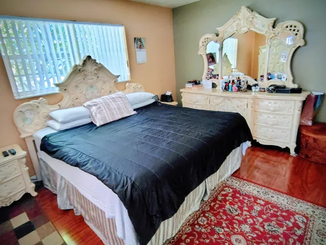 a bed room with a bed mirror and a window